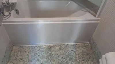 a white bath tub in a bathroom with a tiled floor at Suite Artis Barberini in Rome
