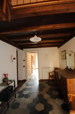 a living room with a wooden ceiling and a checkered floor at Casa Vacanze Colosseo da Fernando no elevator in Rome