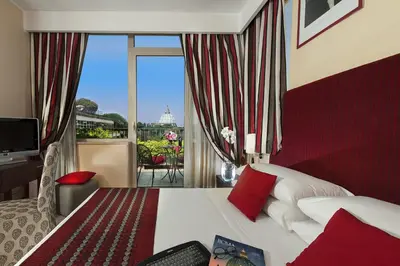a salon with white couches and a waiting room at Cardinal Hotel St. Peter in Rome