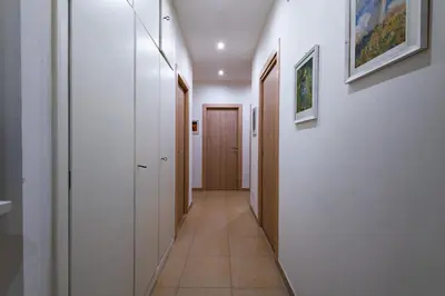 a hallway with white walls and a long corridor at Casa Rosa Beige e Blu in Rome