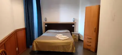 a small bedroom with a bed with two towels on it at Serendipity in Rome