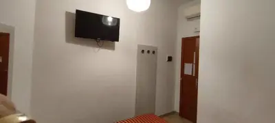 a room with a flat screen tv on a wall at Serendipity in Rome