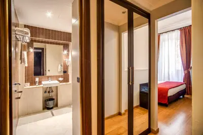 a hotel room with a bed and a bathroom at Hotel Everest Inn Rome in Rome