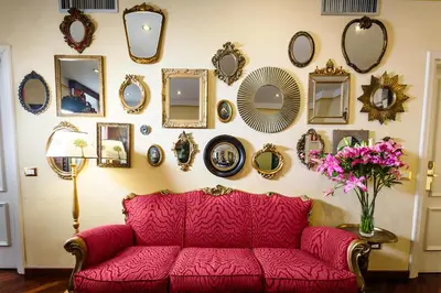 a red couch in front of a wall with mirrors at Casa De' Fiori in Rome