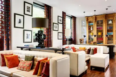 a living room with two couches and a table at Hotel Pulitzer in Rome