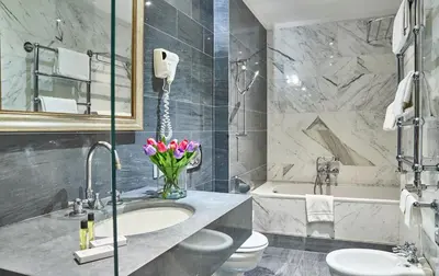 a bathroom with a sink and a toilet and a tub at Hotel Principe Torlonia in Rome