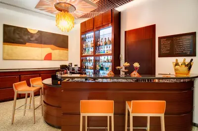 a bar in a restaurant with orange chairs at Hotel Genova in Rome