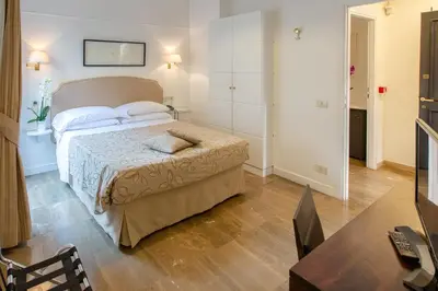 a bedroom with a bed in a room with a table at Hotel Modigliani in Rome