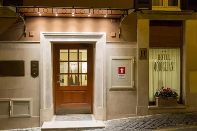 a building with a wooden door with a sign on it at Hotel Modigliani in Rome