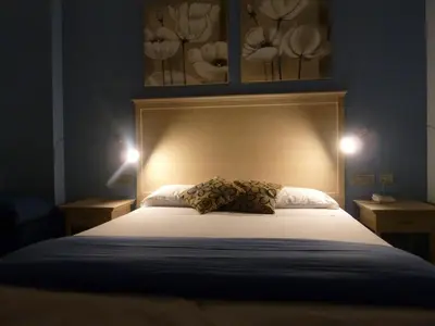 a bed with two pillows on it in a room at Casa Eli Roma B&B in Rome