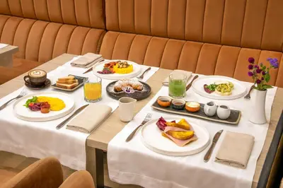 a table with plates of breakfast food on it at Condotti Boutique Hotel in Rome