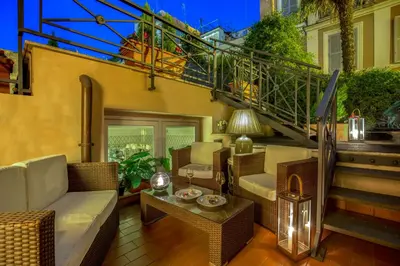a living room with a couch and chairs and stairs at Hotel Villa Glori in Rome