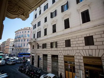 a tall building with cars parked on a city street at Rome Holiday Home in Rome