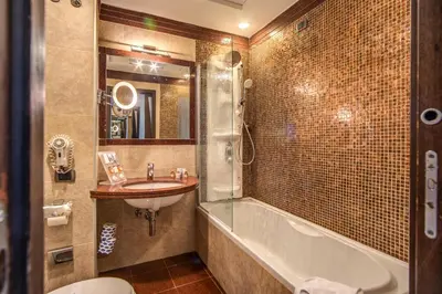 a bathroom with a sink and a tub and a toilet at Kolbe Hotel Rome in Rome