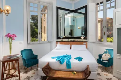 a bedroom with a bed with a blue bow on it at Hotel Emona Aquaeductus in Rome