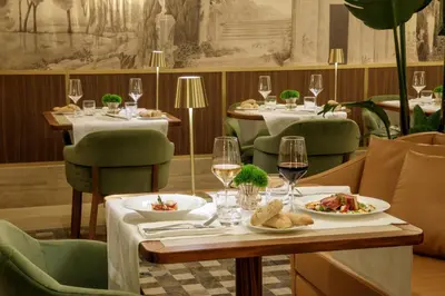 a hotel room with a large white bed and a chair at Hotel Imperiale by OMNIA hotels in Rome
