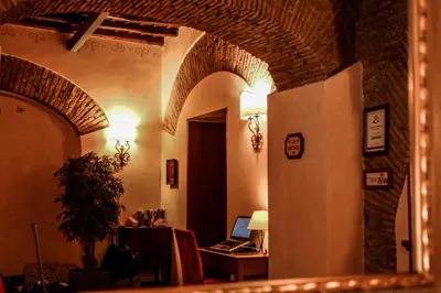 a room with an archway with a laptop on a desk at Residenza San Calisto in Rome