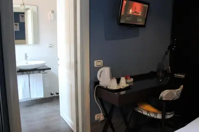 a bathroom with a sink and a counter with a toilet at Locanda degli Antiquari in Rome