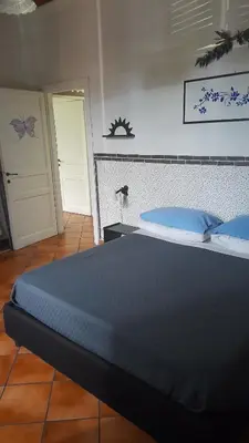 a bedroom with a large bed with blue pillows at Testaccio comodo appartamento in Rome