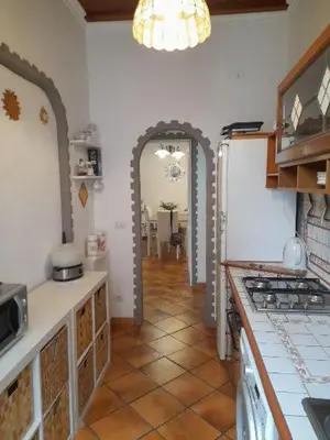 a kitchen with an archway leading to a dining room at Testaccio comodo appartamento in Rome