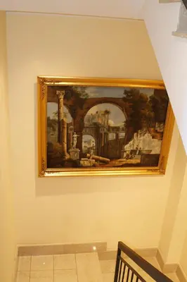 a painting hanging on a wall in a museum at Boutique Hotel Trevi in Rome