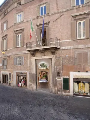 a building with a balcony and two flags on it at Pantheon Inn in Rome