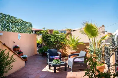 a patio with chairs and plants on a building at Pantheon Inn in Rome