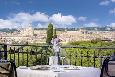 a table with a view of the vatican city at Hotel Splendide Royal - The Leading Hotels of the World in Rome