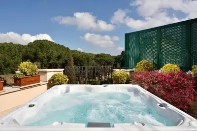 a jacuzzi tub on a patio with flowers at Hotel Splendide Royal - The Leading Hotels of the World in Rome