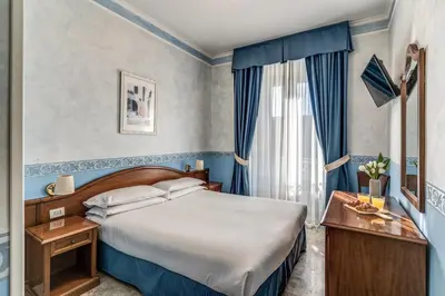 a hotel room with a bed and a window at Hotel Orazia in Rome