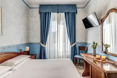 a hotel room with a bed and a desk at Hotel Orazia in Rome