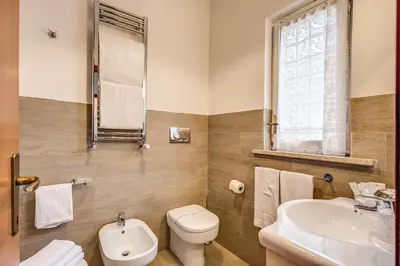 a bathroom with a toilet and a sink at Hotel Residence Magnolia in Rome