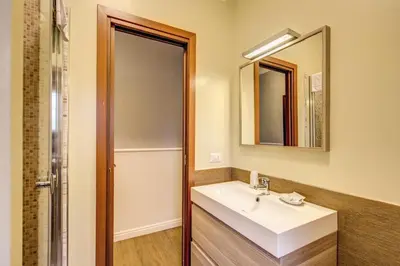 a bathroom with a sink and a mirror at Hotel Residence Magnolia in Rome