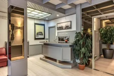 a large room with a hair salon with a mirror at Hotel Residence Magnolia in Rome