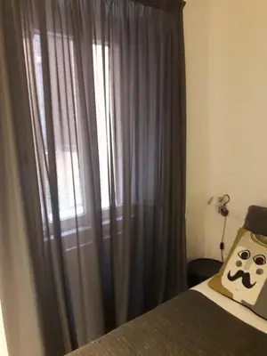 a bedroom with a bed and a window with drapes at EasyInRome Navona in Rome