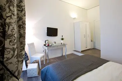 a bedroom with a bed and a desk with a television at Rome Key Home in Rome