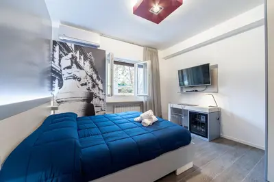 a bedroom with a blue bed and a television at Il Rosso e il Blu in Rome