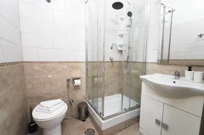 a bathroom with a shower and a toilet and a sink at Cicero Rome Center in Rome
