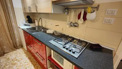 a small kitchen with a stove and a sink at Sergio Tourist Rental close Tiburtina Station in Rome