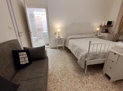 a bedroom with a bed and a couch at Sergio Tourist Rental close Tiburtina Station in Rome
