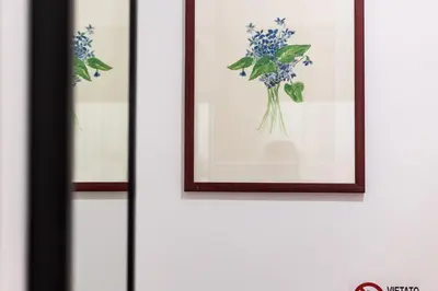 a framed picture of flowers on a wall at Penelope Holiday in Rome