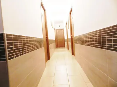 a hallway with a row of stalls in a bathroom at Vatican Rome in Rome