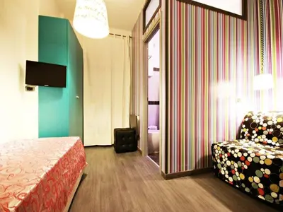 a hotel room with a bed and a chair at Affittacamere Tiburstation in Rome