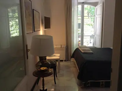 a bedroom with a bed and a lamp on a table at 2 Be Home Colosseo in Rome
