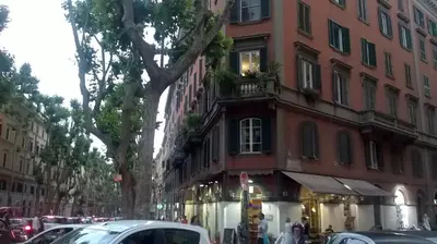 a building on a city street with cars parked in front at 2 Be Home Colosseo in Rome
