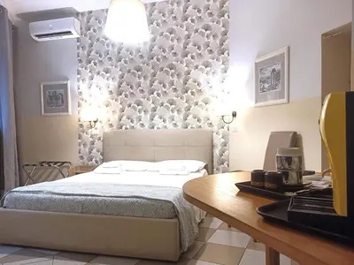 a bedroom with a bed and a desk and a table sidx sidx sidx at Sweet Dreams Roma in Rome