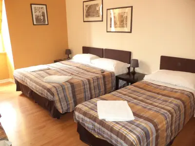 a hotel room with two beds in a room at Enjoy Roma in Rome