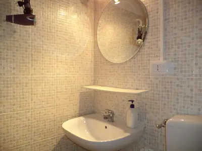 a bathroom with a sink and a mirror and a toilet at Enjoy Roma in Rome