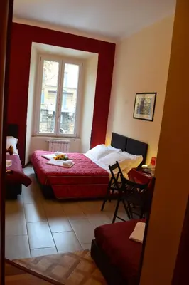 a bedroom with two beds and a window at Enjoy Roma in Rome