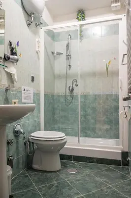 a bathroom with a shower and a toilet and a sink at San Pietro's Home in Rome